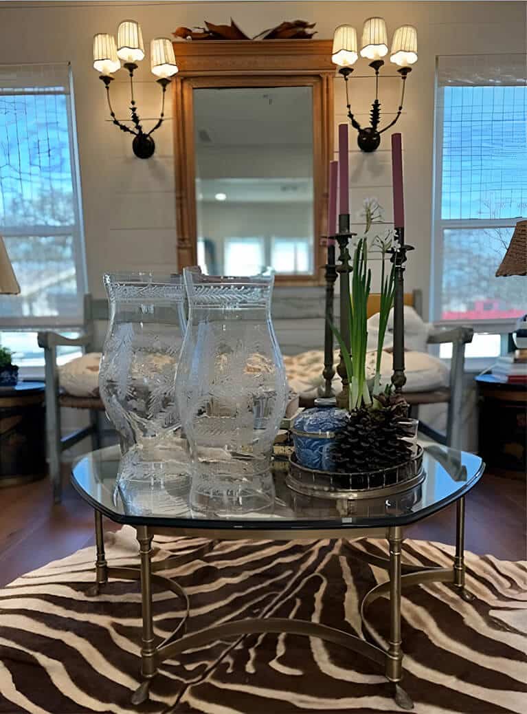 Glass-topped console styled with antlers, candlesticks and trailing greenery