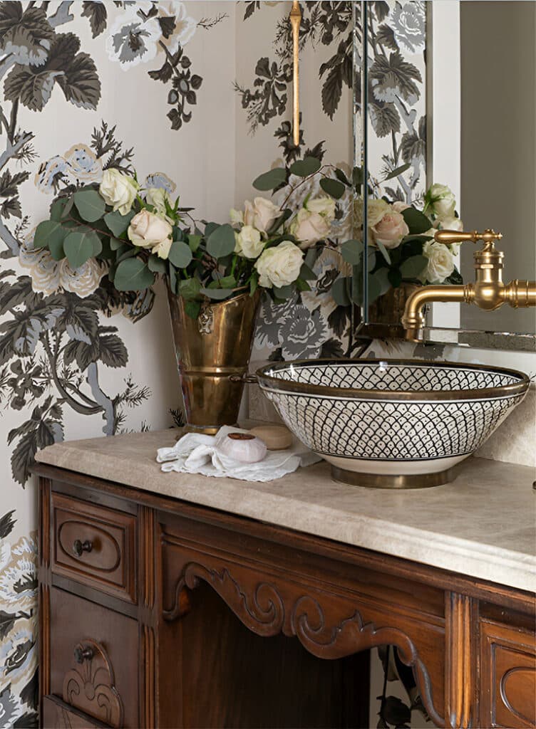 Wooden chest styled with a large ceramic bowl and white blooms